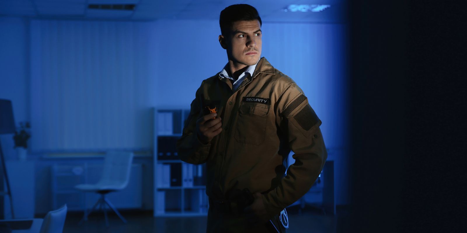 Security Guard with Portable Radio Set in Business Building After Hours